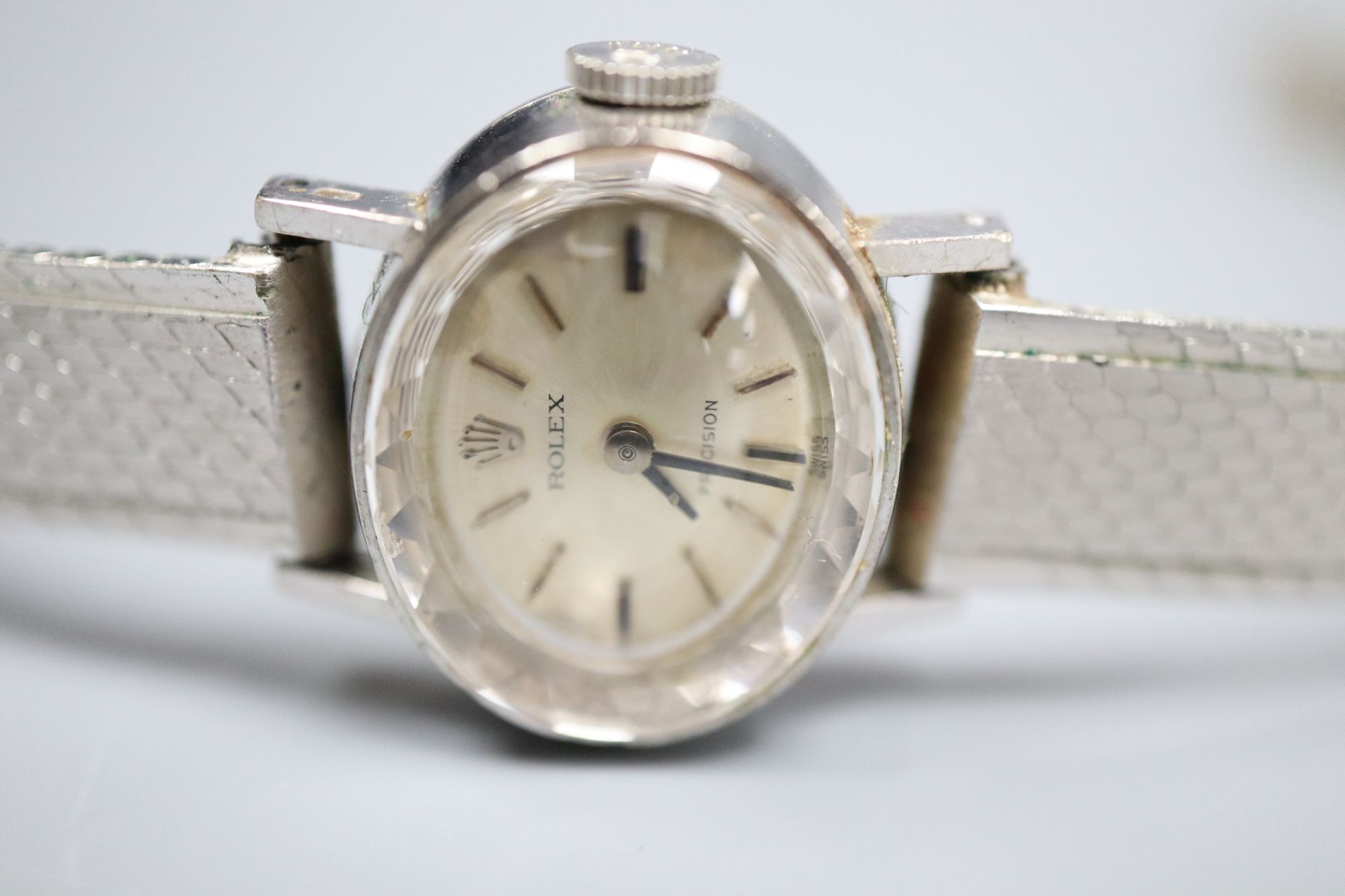 A ladys 18ct gold Rolex precision manual wind oval wrist watch, on a rhodium bracelet, overall 19cm, gross 26.8 grams.